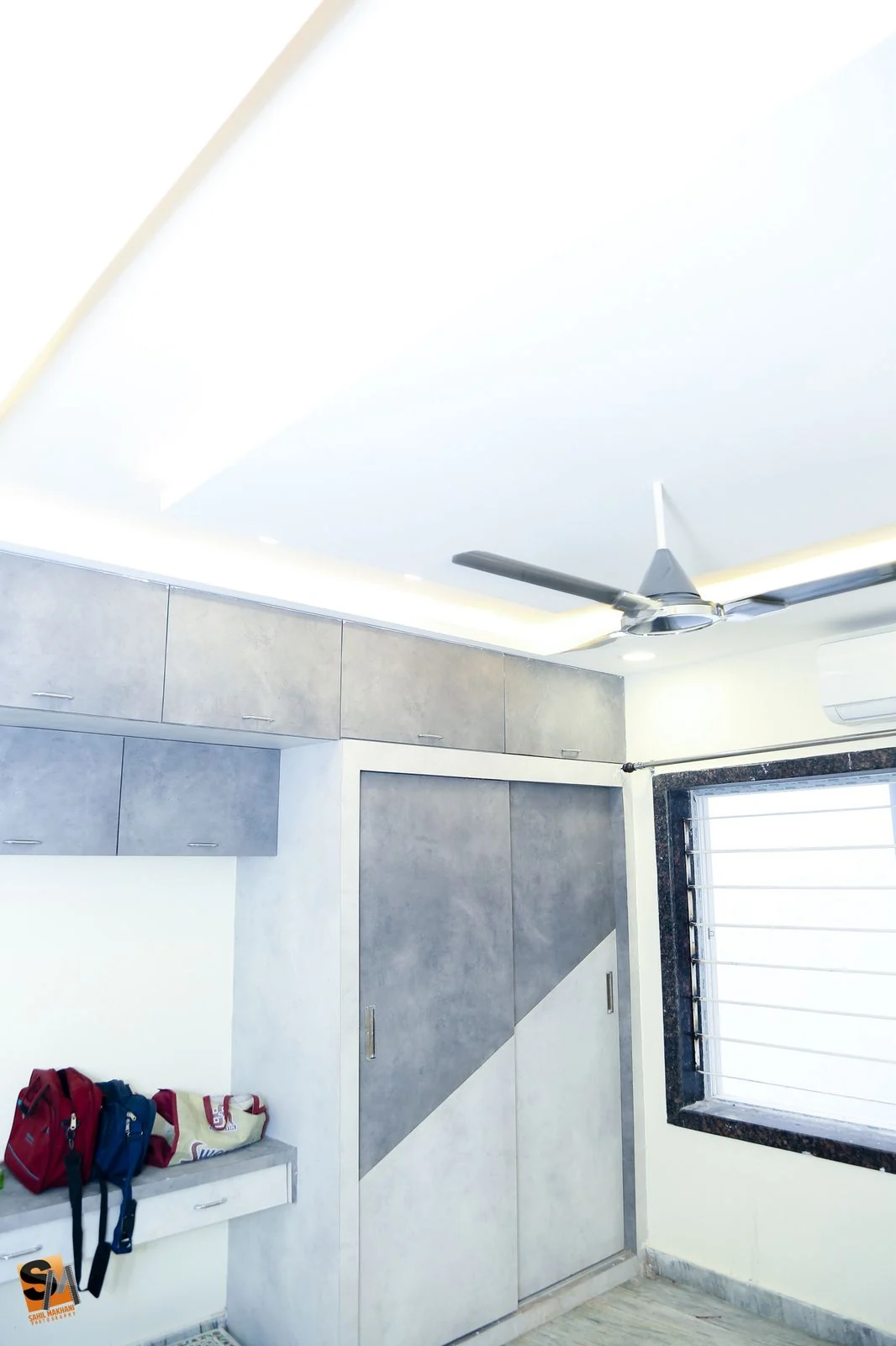 Bathroom in grey tile with a window and vanity shelf