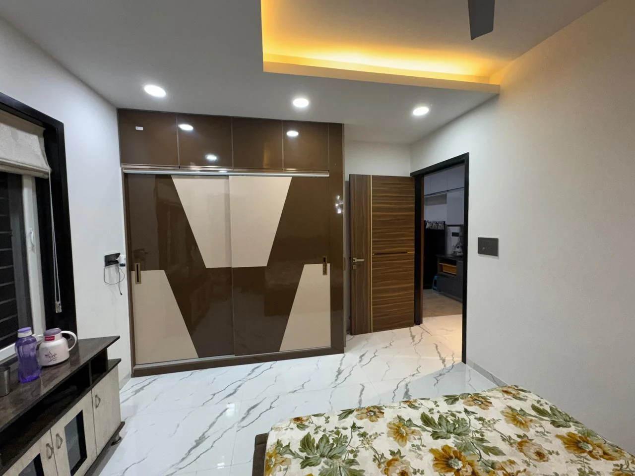 Bedroom wardrobe in brown gloss with a chevron pattern across the shutters