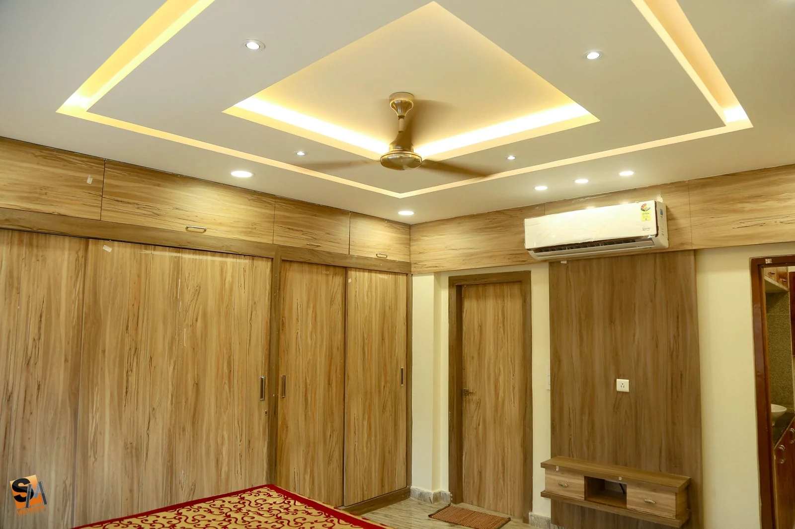Full-height timber wardrobe wall beneath a cove ceiling