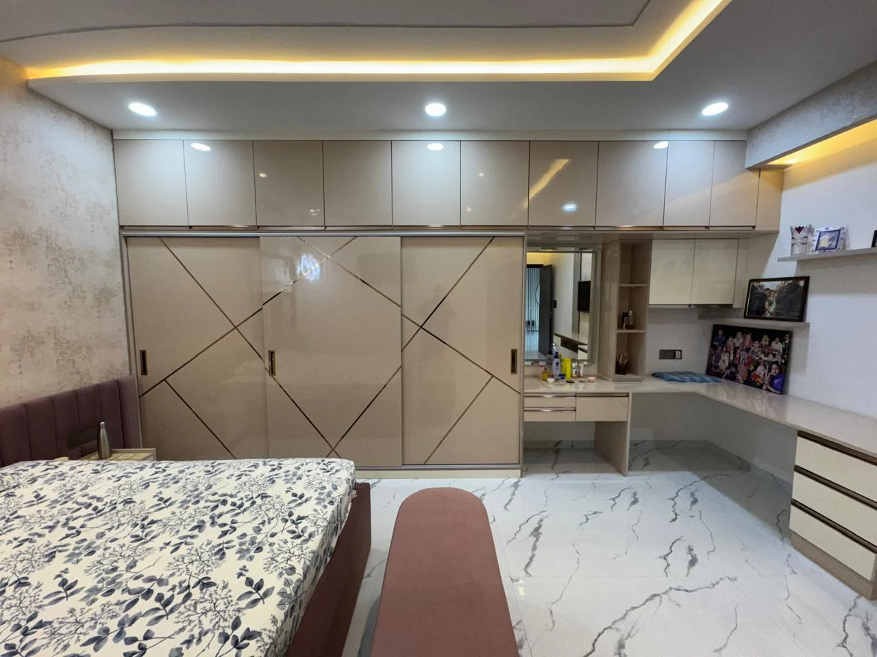Bedroom gloss wardrobes with a dressing table and mirror set into the joinery