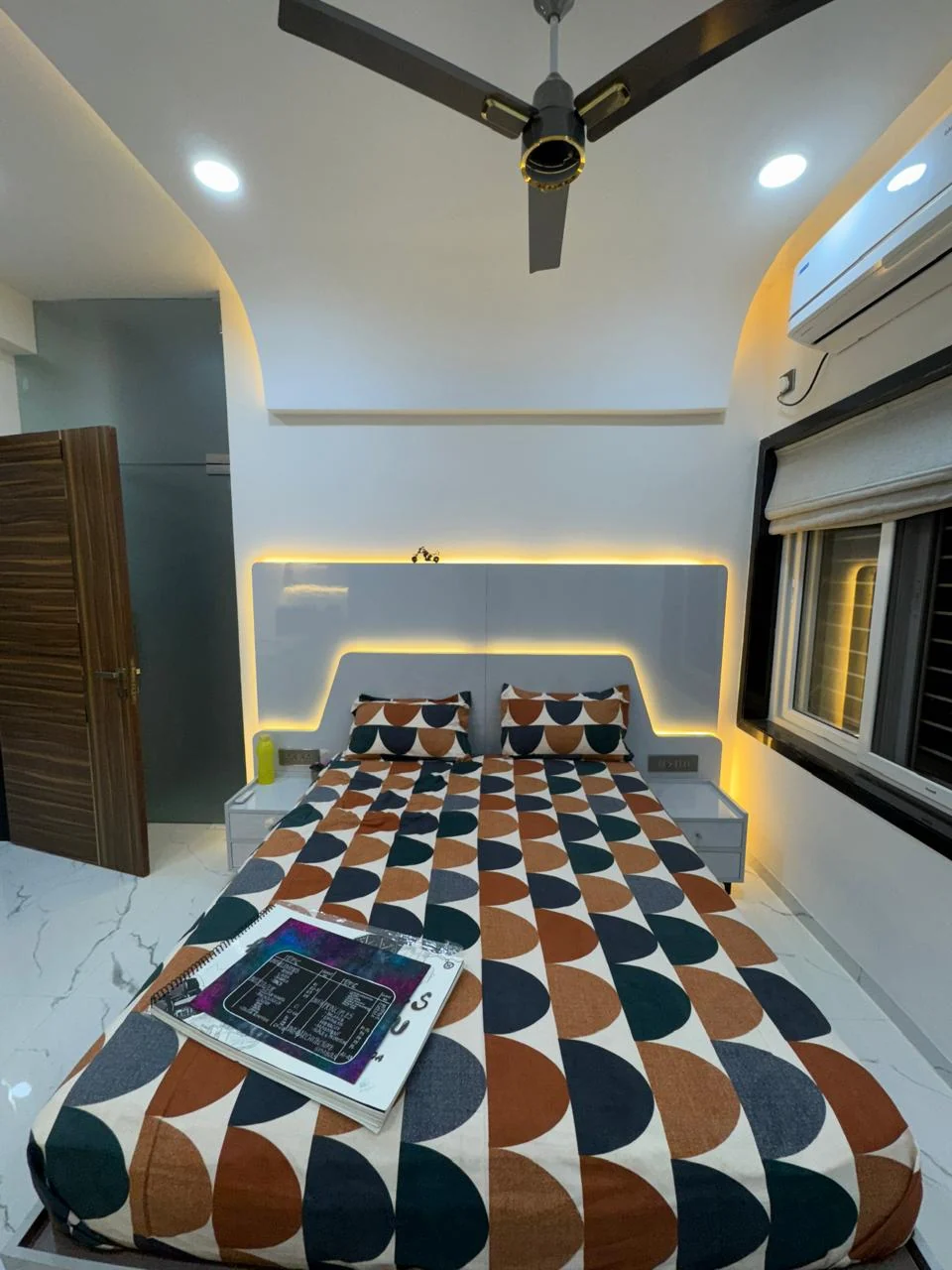 Bedroom with a headboard recessed into the wall and concealed LED behind its edge