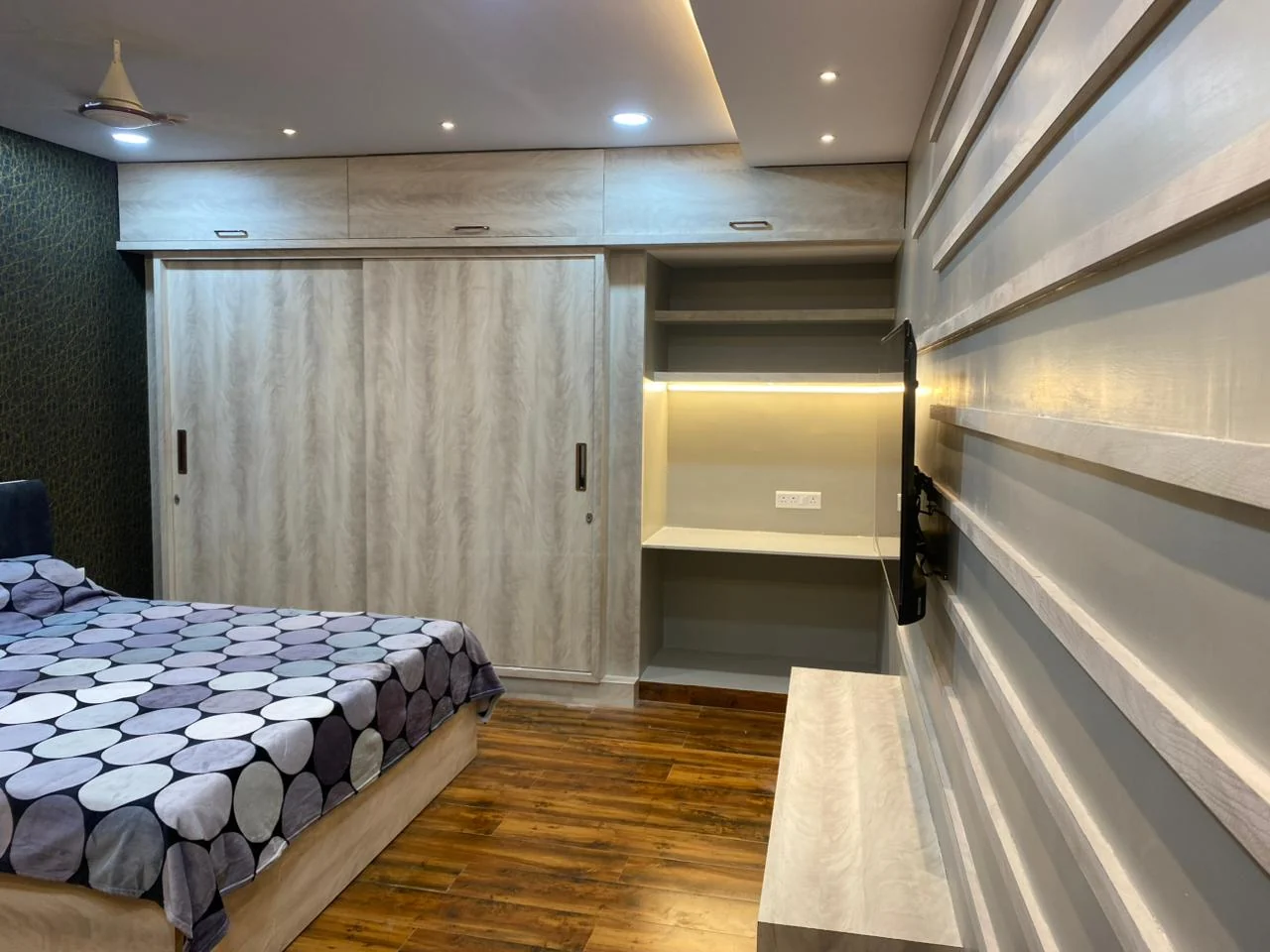 Detail of a pale timber wardrobe run against slat panelling