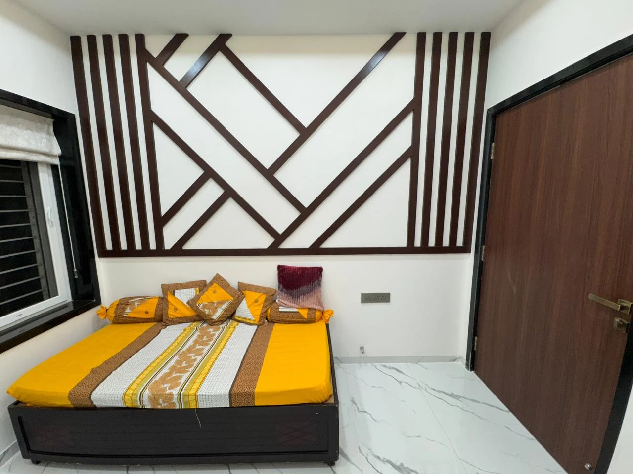 Bedroom with a timber batten feature wall cut into a large geometric pattern