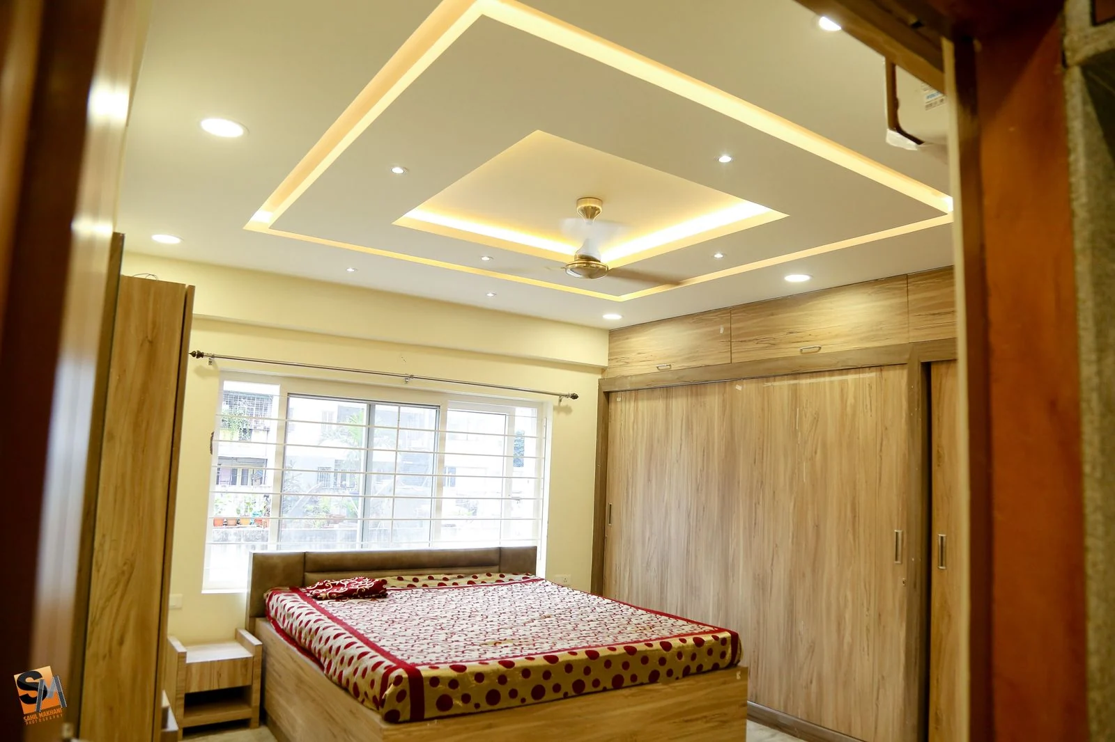 Bedroom timber wardrobe run beneath a recessed cove ceiling