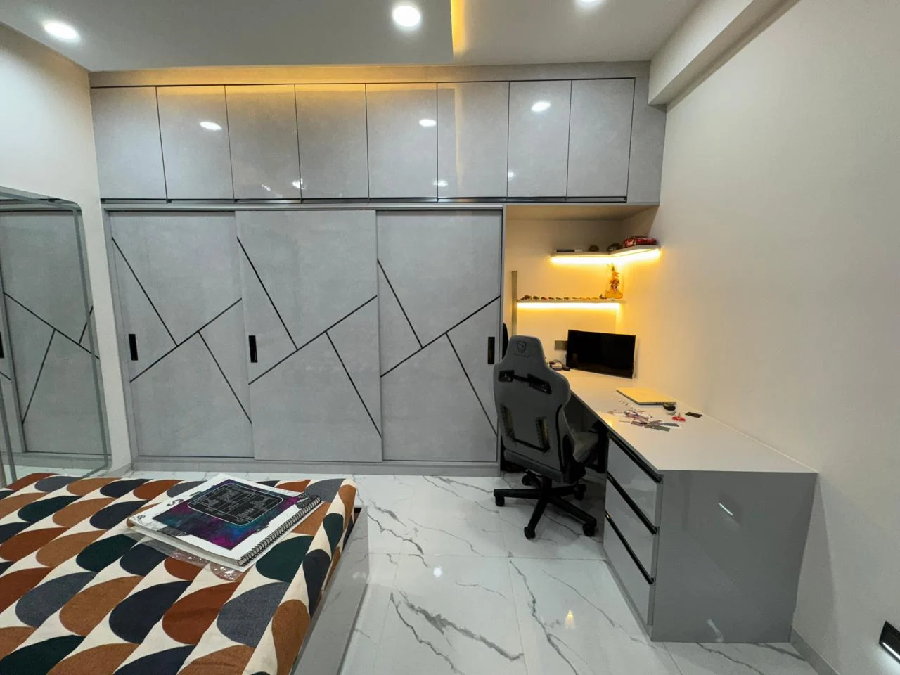 Geometric groove detail across a wardrobe wall, with the study return alongside