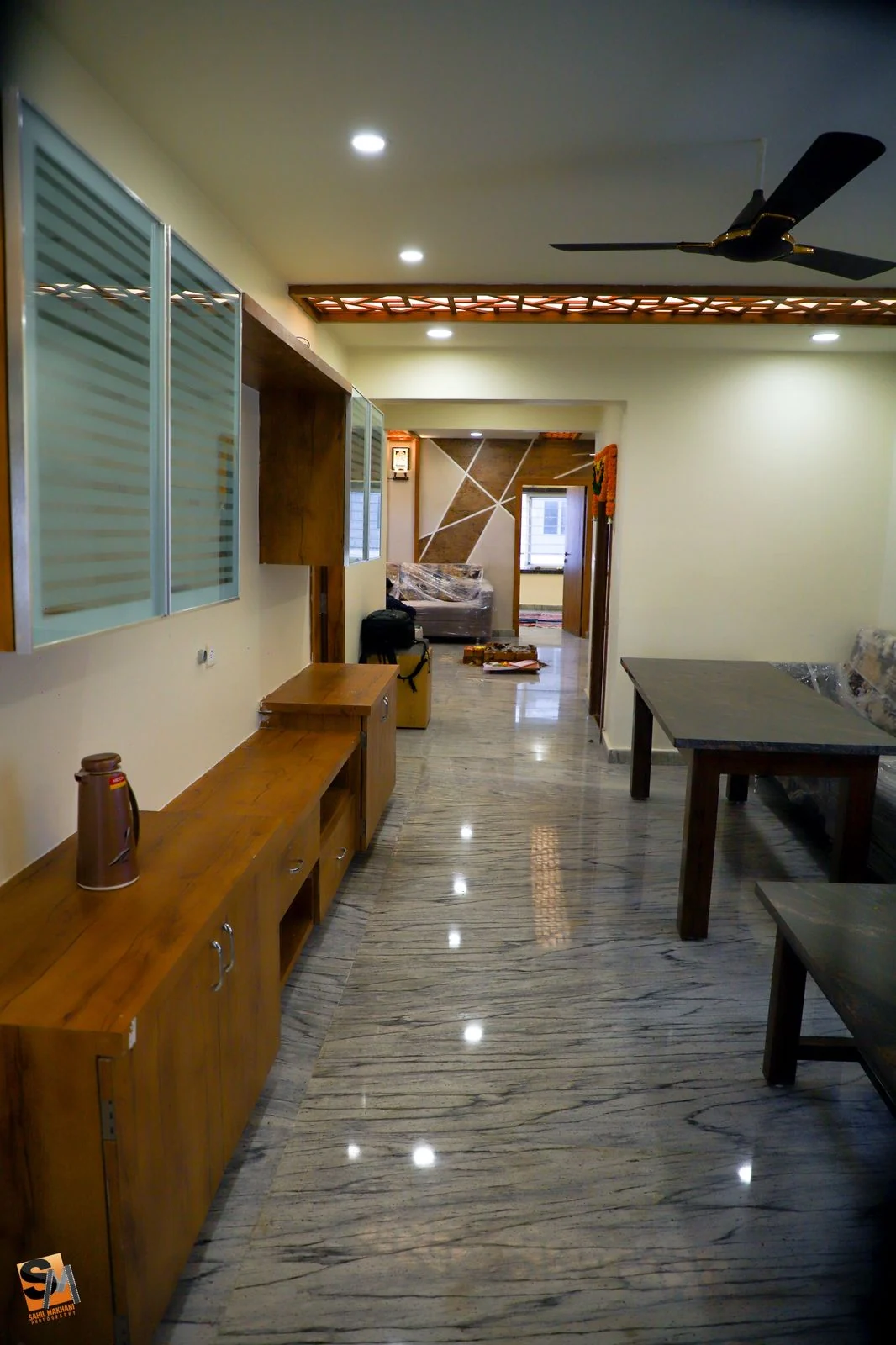 Timber sideboard along the dining corridor above a marble floor