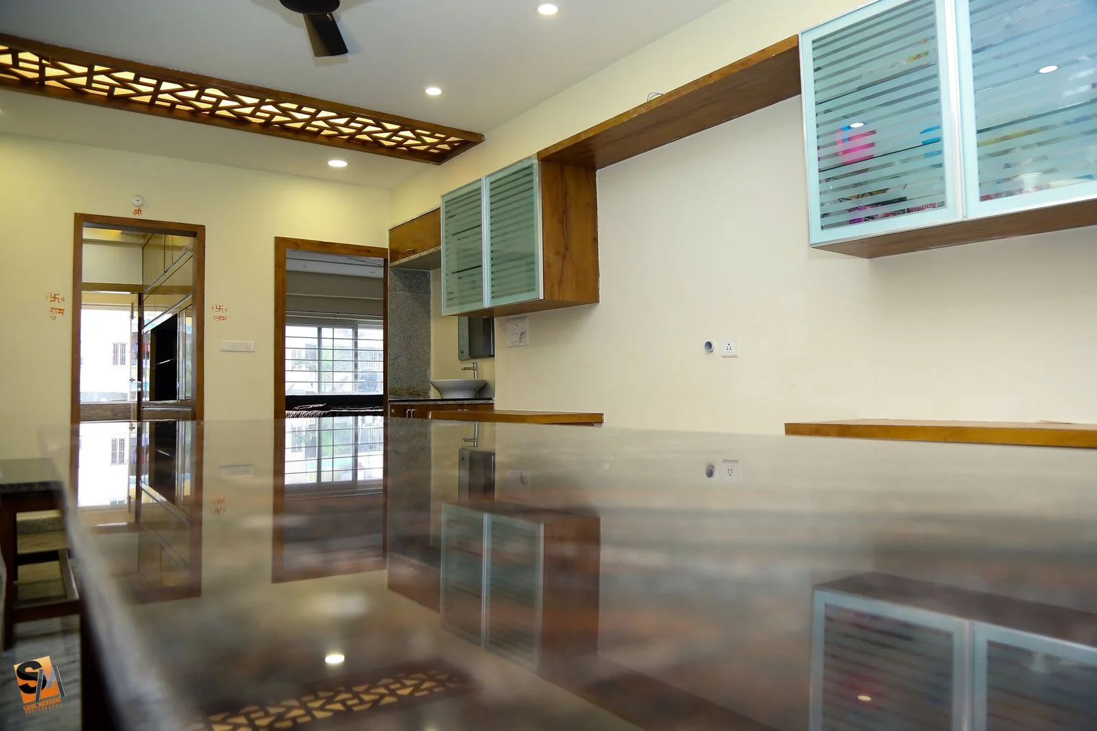 Daylight reflected across the polished dining counter beneath glass cabinets
