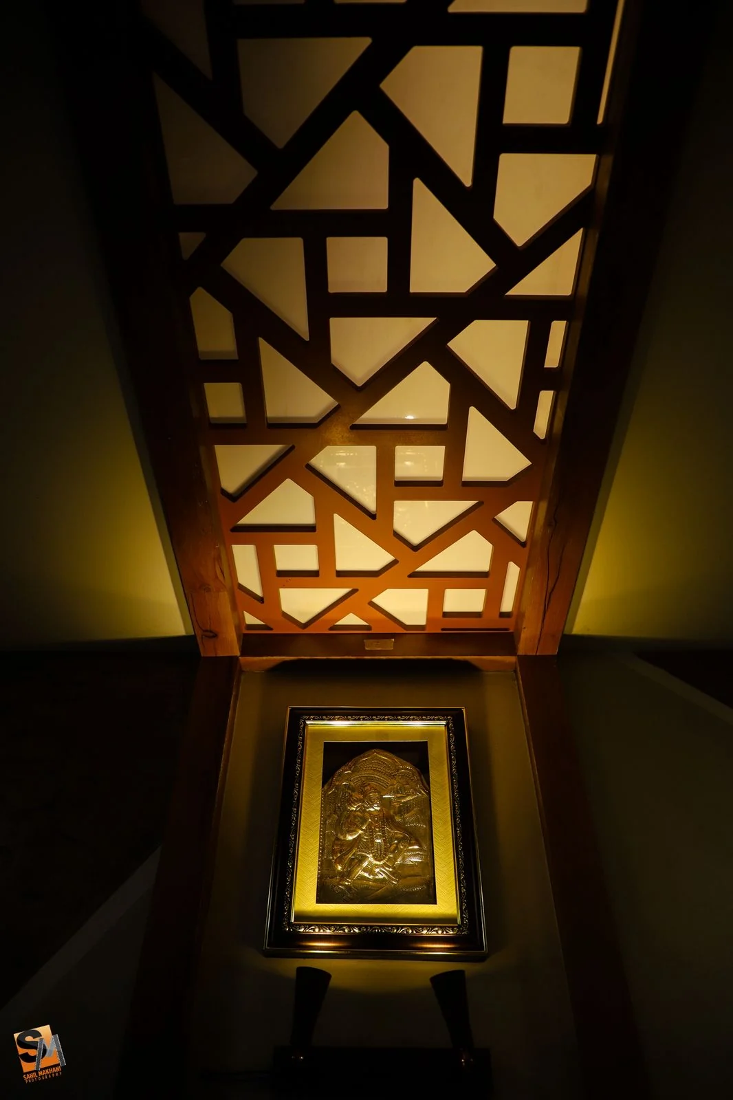 CNC-cut timber fretwork ceiling panel lit from behind