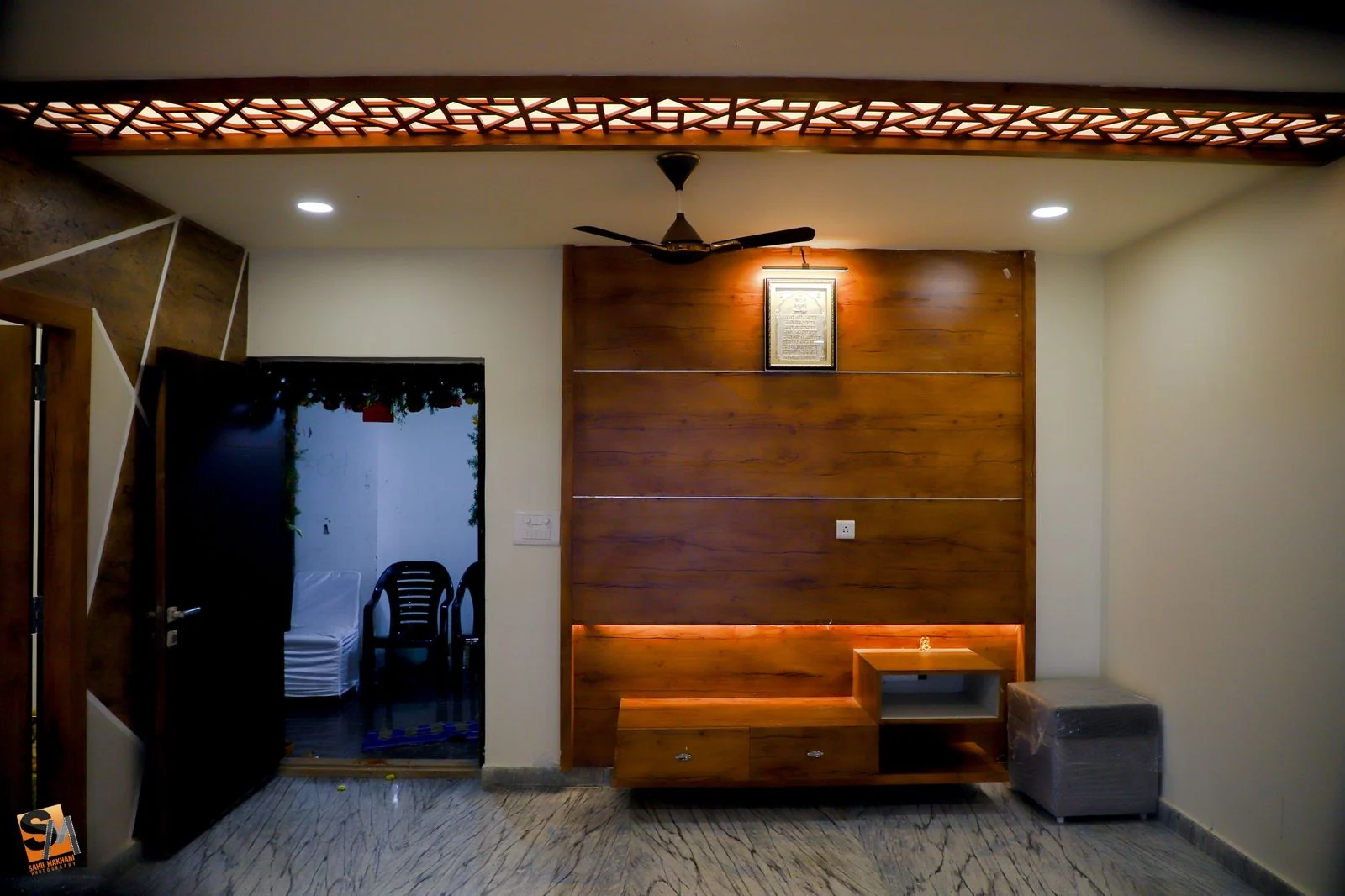 Timber panel wall with a backlit floating console in the hall