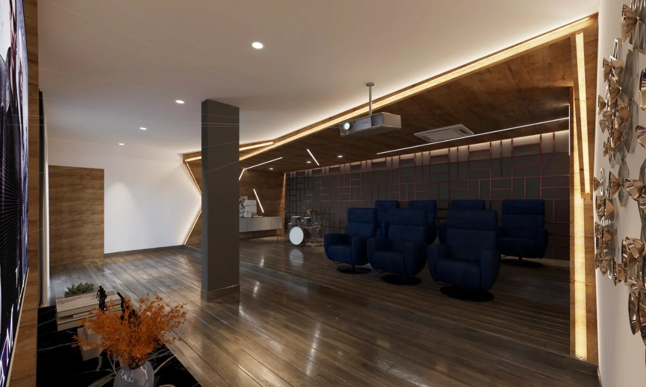 Angled ceiling coffers stepping down towards the screen above tiered recliner rows