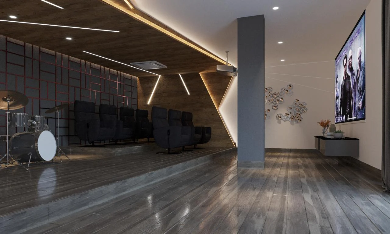 Faceted acoustic wall panels edged with concealed linear lighting beside tiered recliners