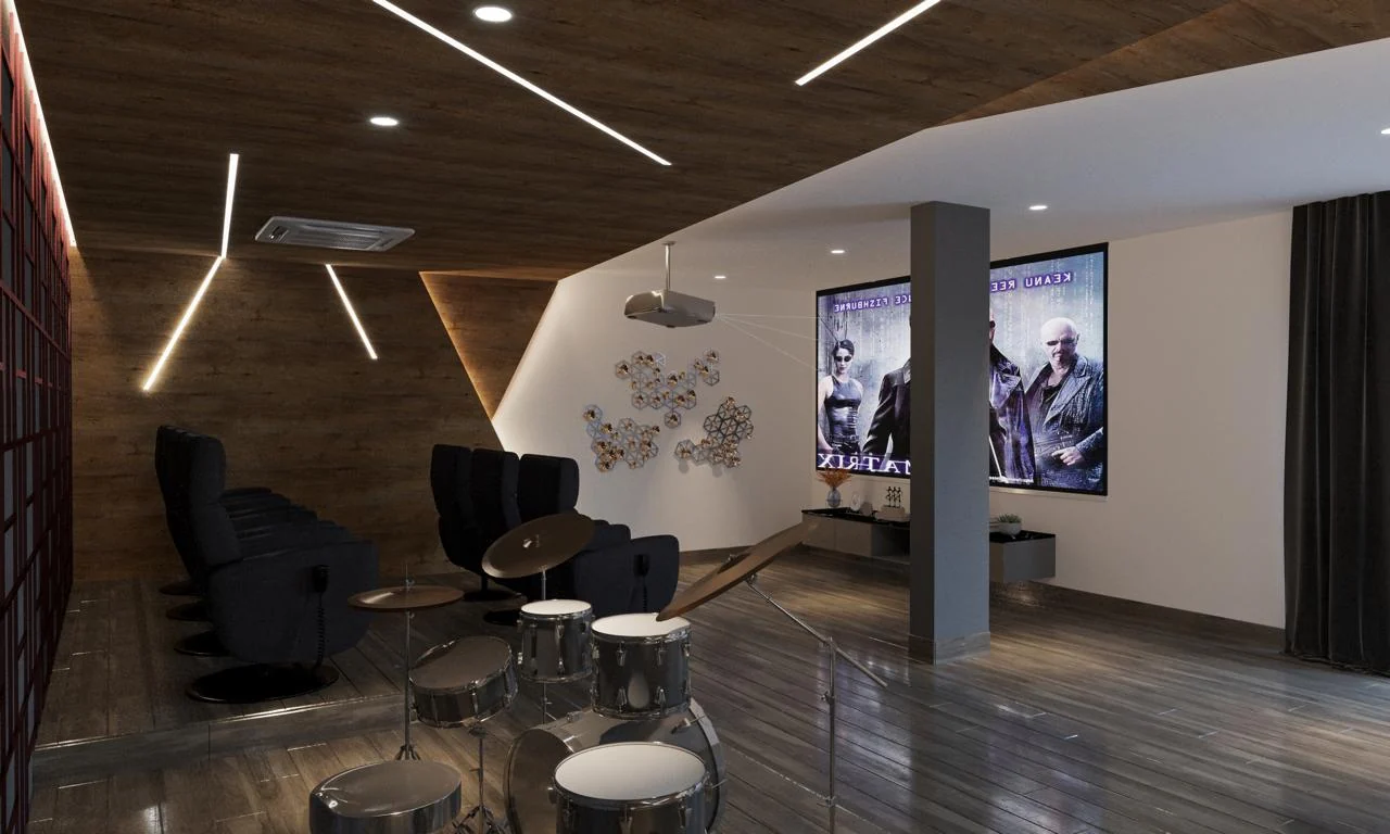 Completed private home theatre with tiered recliner seating, a wall-width projection screen, faceted acoustic wall panels and linear ceiling lighting