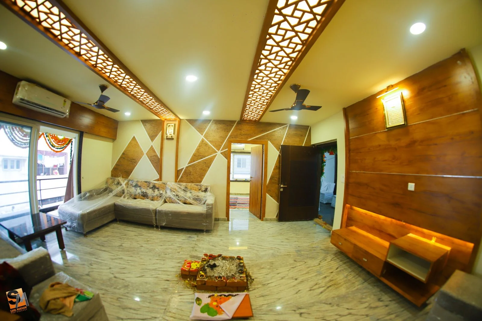Living room fretwork arch ceiling above a geometric triangular feature wall