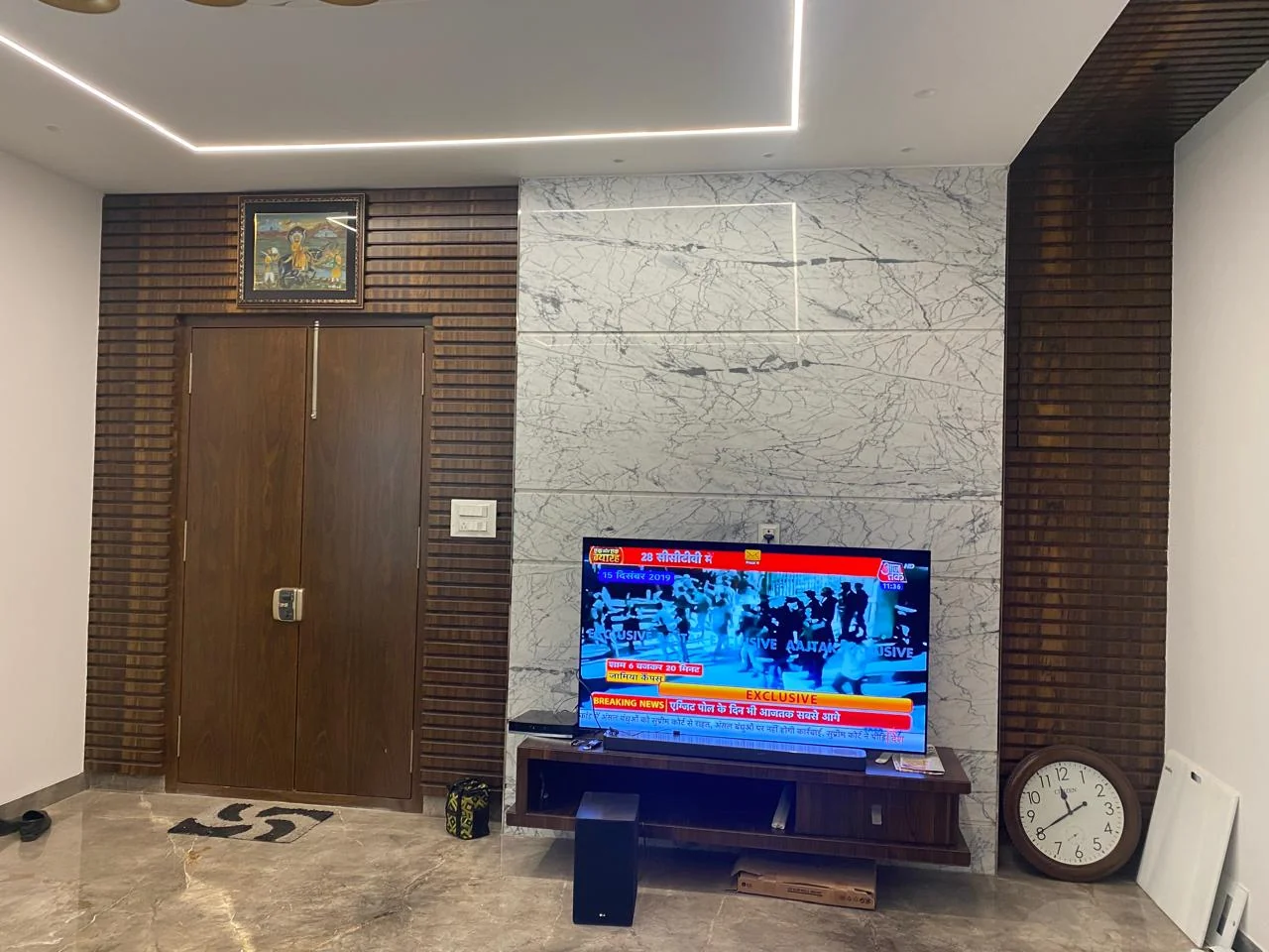 Marble television wall with vertical timber batten panelling