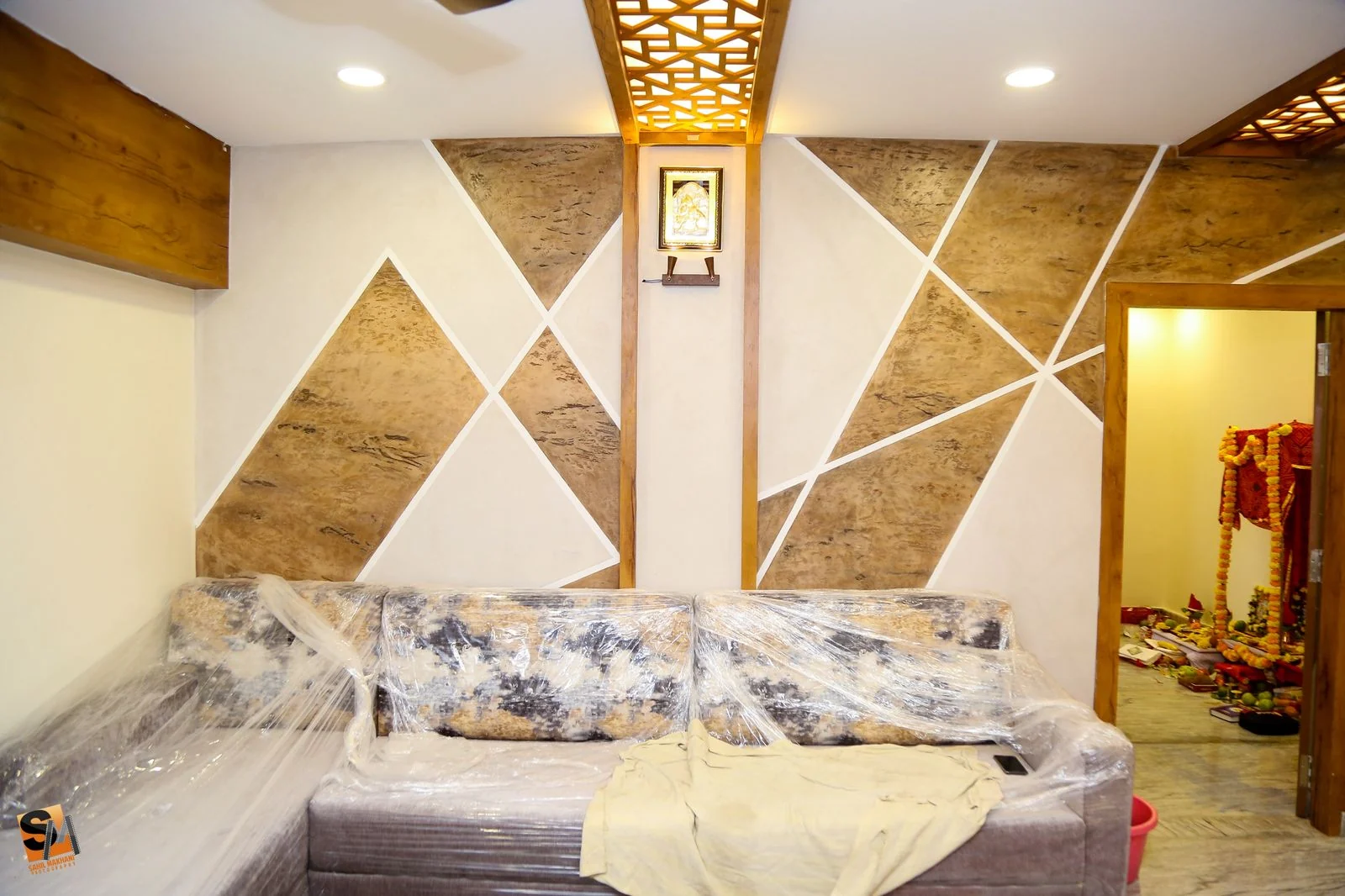 Living room stone triangle feature wall beside a fretwork panel