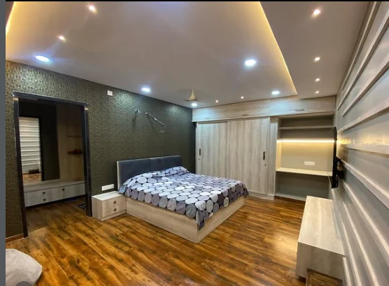 Master bedroom detail showing textured accent wall and integrated storage