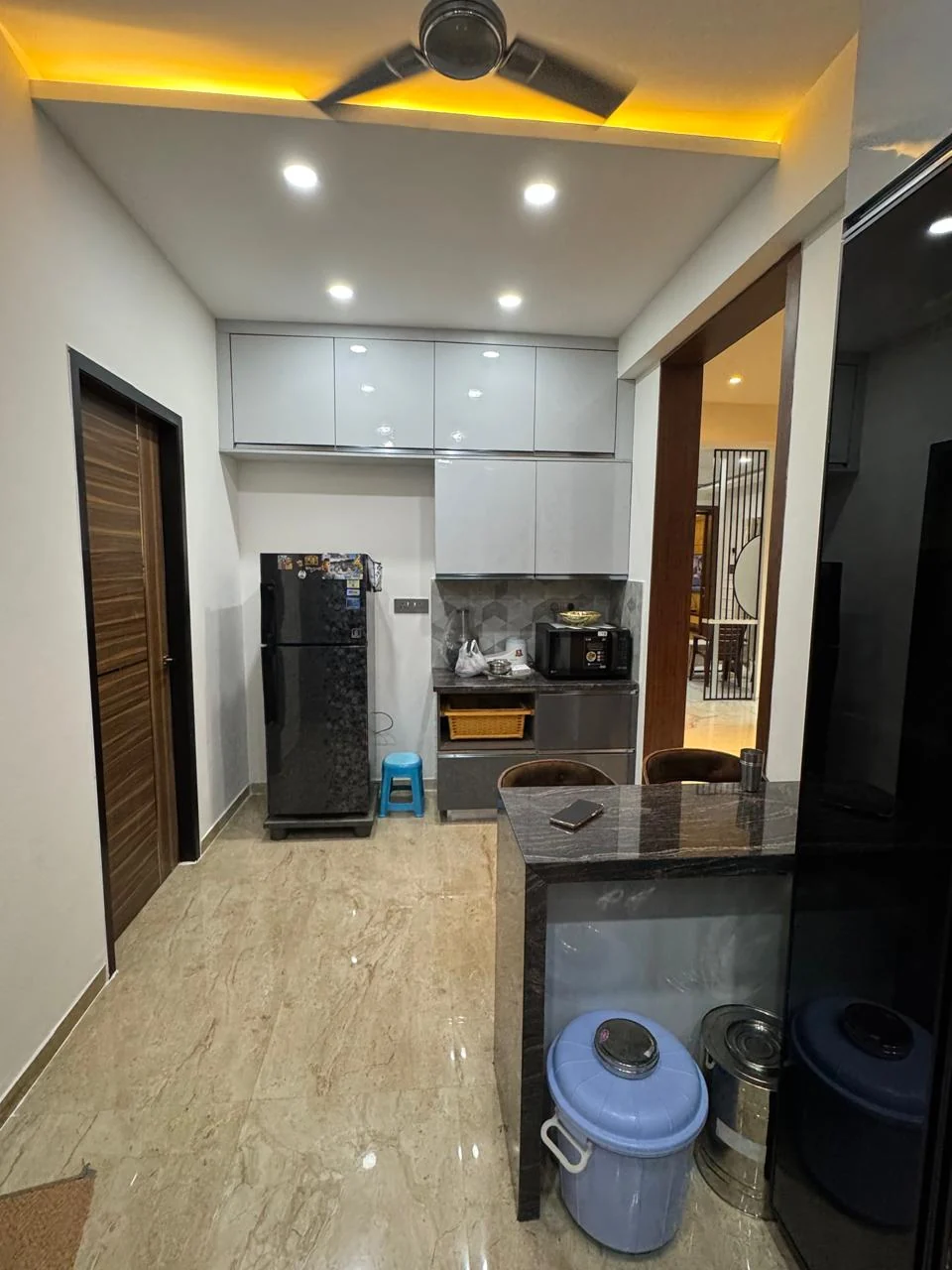 Modular kitchen breakfast counter beside the appliance run