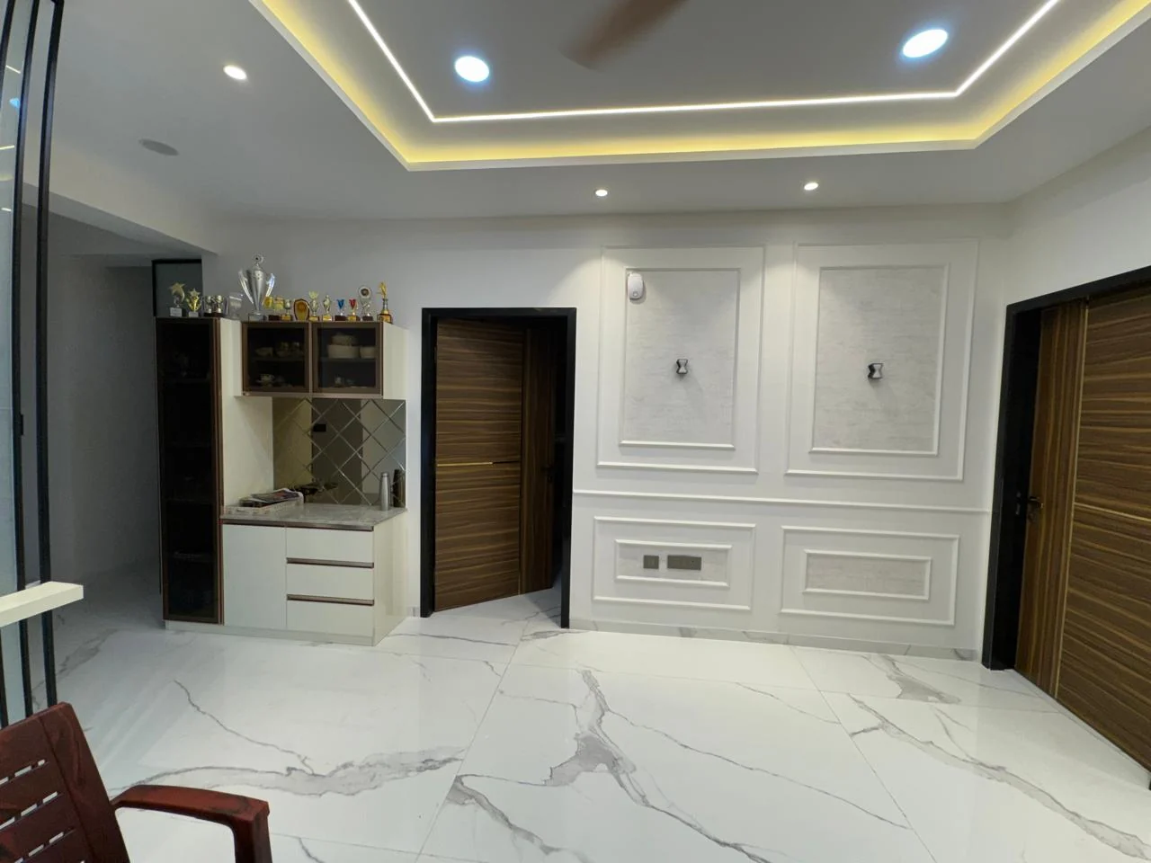 Formal hall with a built-in crockery unit set within moulded wall panelling