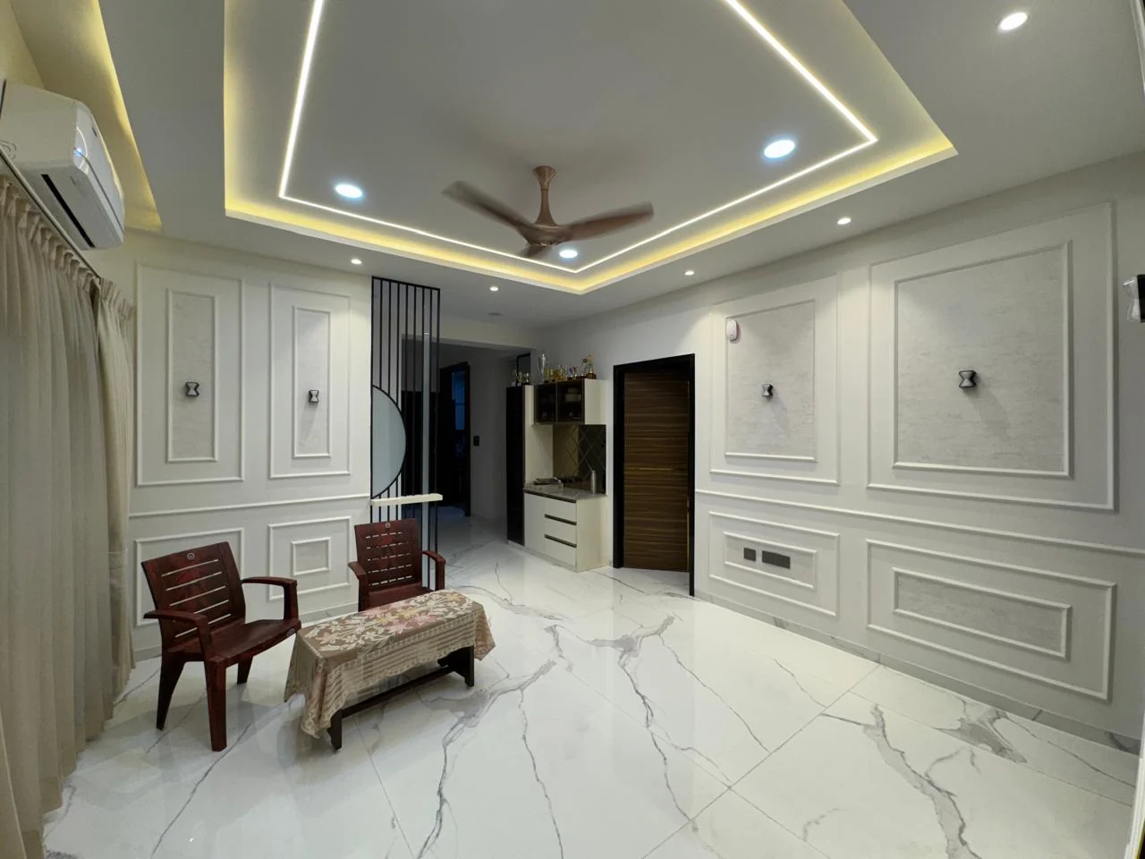 Panelled hall seen across the seating, with full-height moulded wall panels