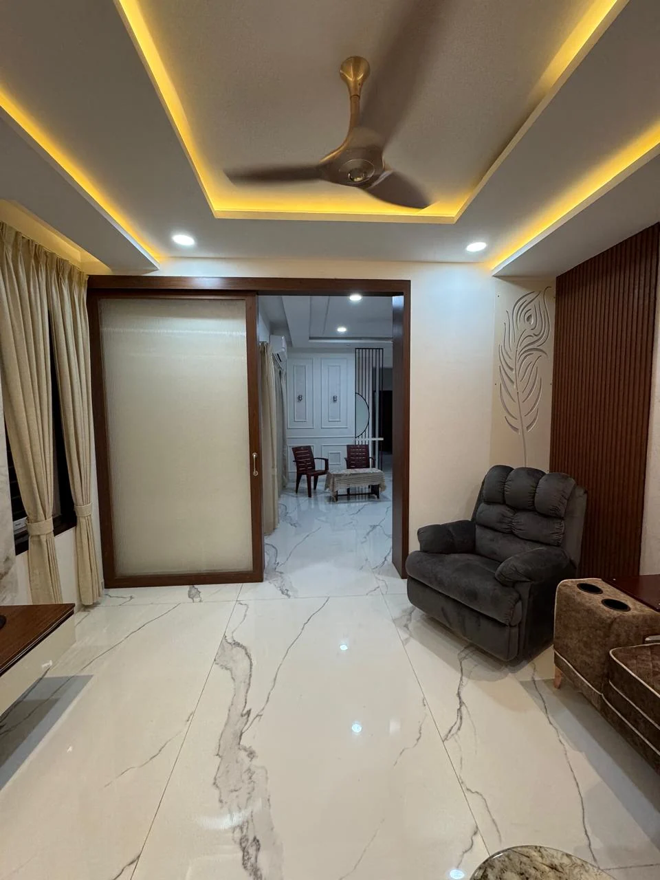 Passage leading to the panelled hall across large-format marble flooring