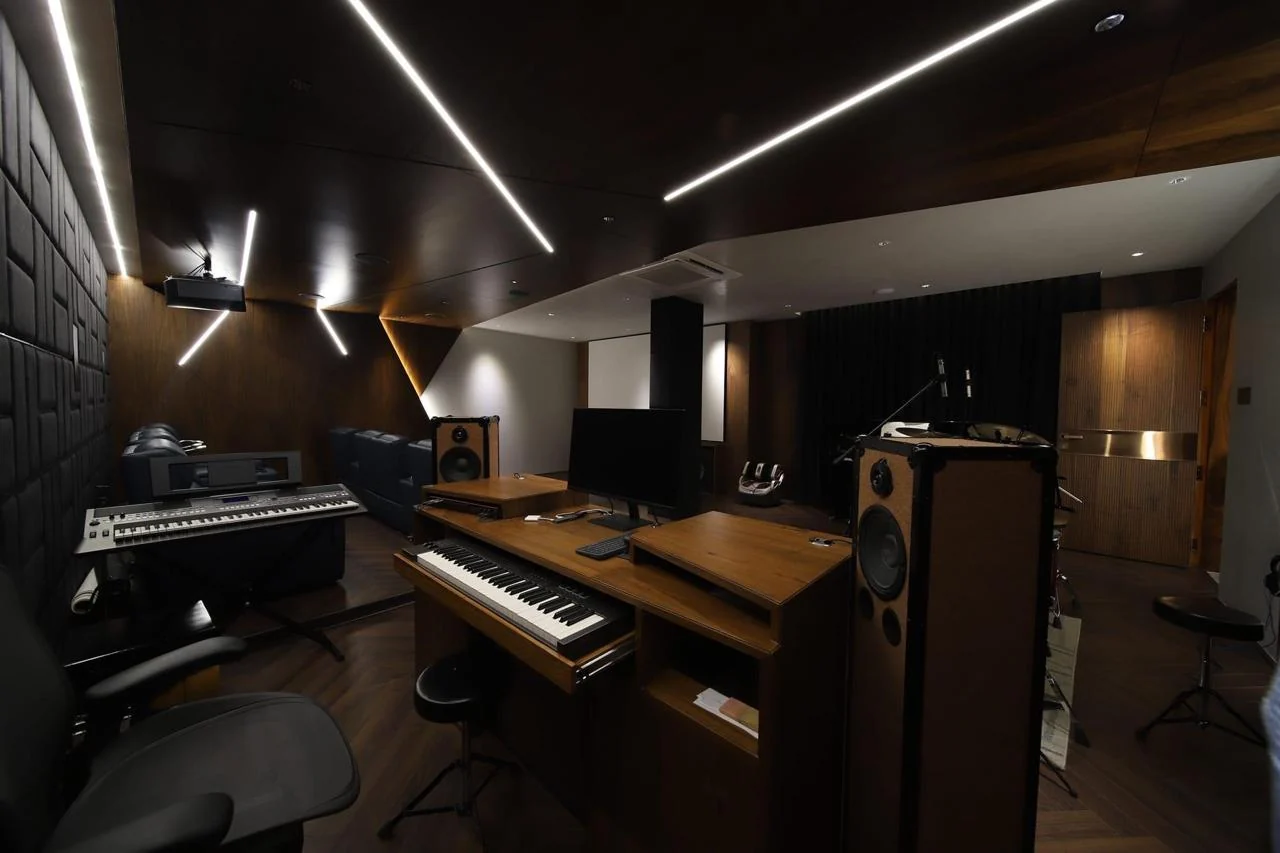 Recording control desk in solid timber with studio monitors and a MIDI keyboard