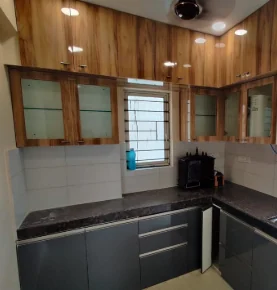 Corner storage detail showing continuous granite counter and woodgrain cabinetry