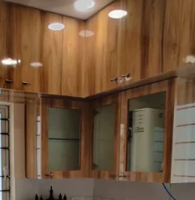 Woodgrain wall cabinets with frosted glass shutters and recessed lighting